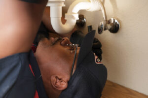 Goettl technician fixing a sink pipe