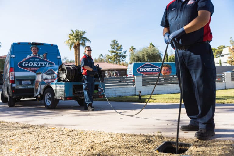 Goettl plumbers putting a hydro jet down a sewer line