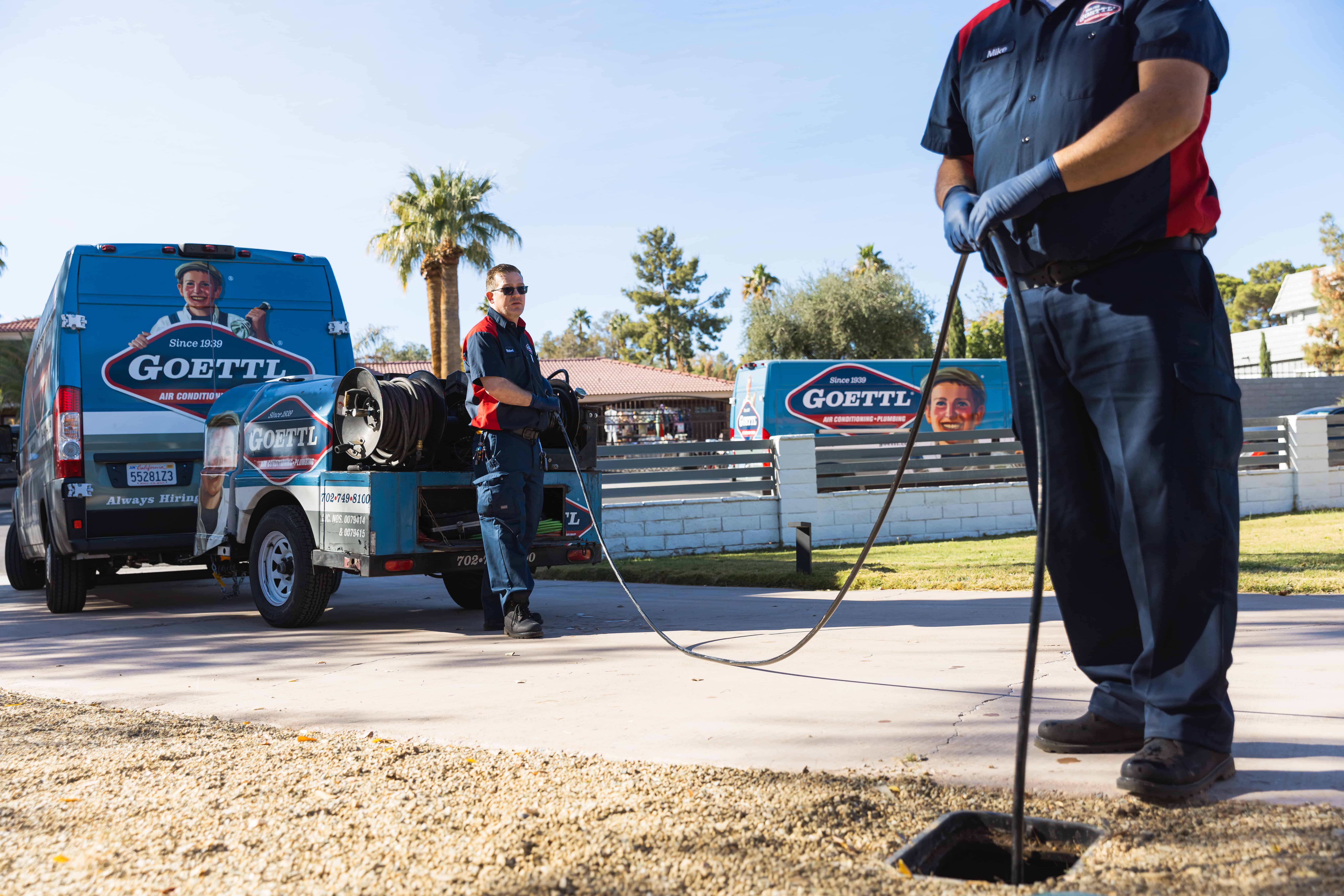 Goettl plumbers putting a hydro jet down a sewer line