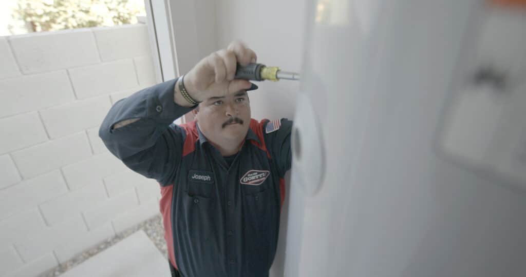 Goettl Worker Repairing Water Heater
