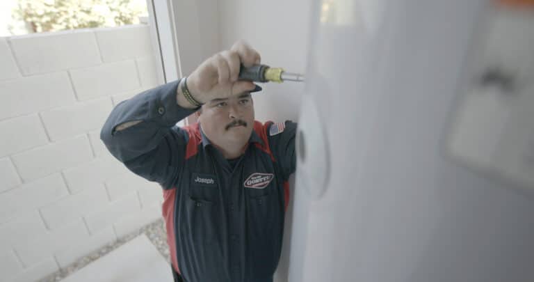 Goettl Worker Repairing Water Heater