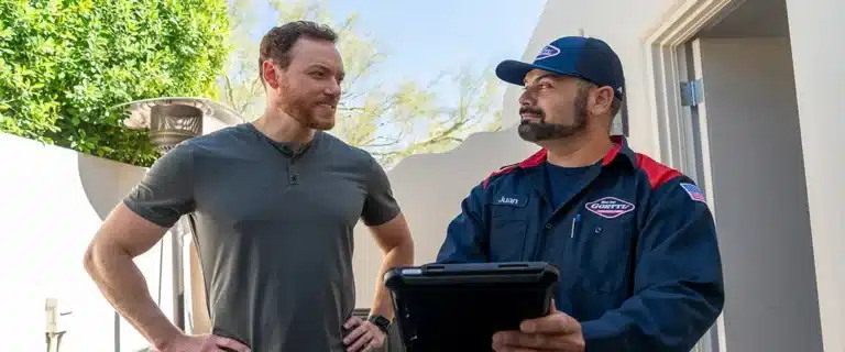 Goettl Technicians holding a clipboard helping a customer