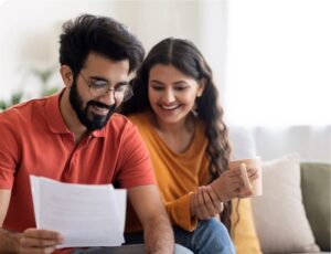 couple on couch balancing budget promo get pre approved