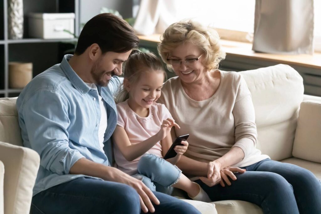 happy grandma son granddaughter on couch after goettl furnace repair service