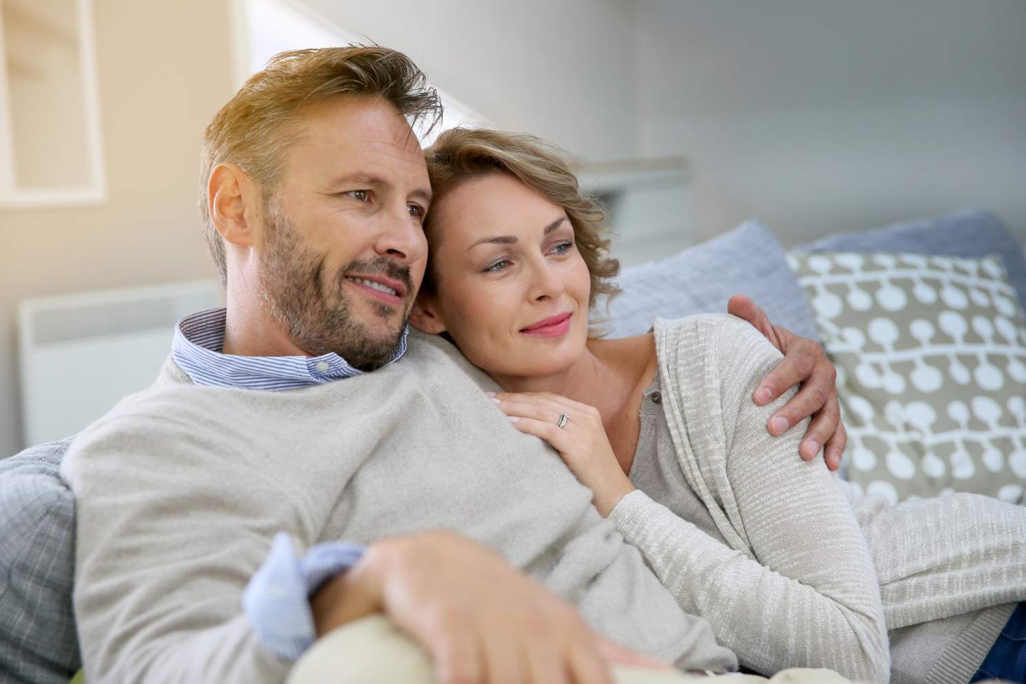 Happy middle aged couple on couch