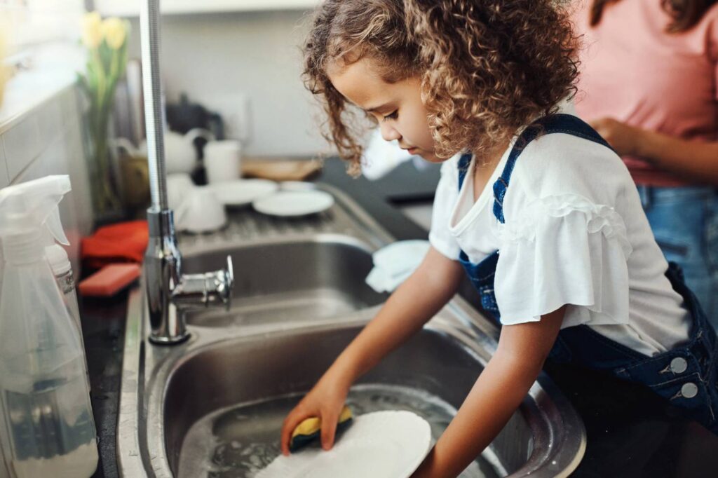 Mother and Daughter Enjoying Hot Water for Dishes