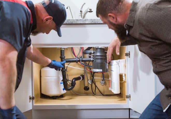 Goettl Technician showing customer finished plumbing installation work done under sink